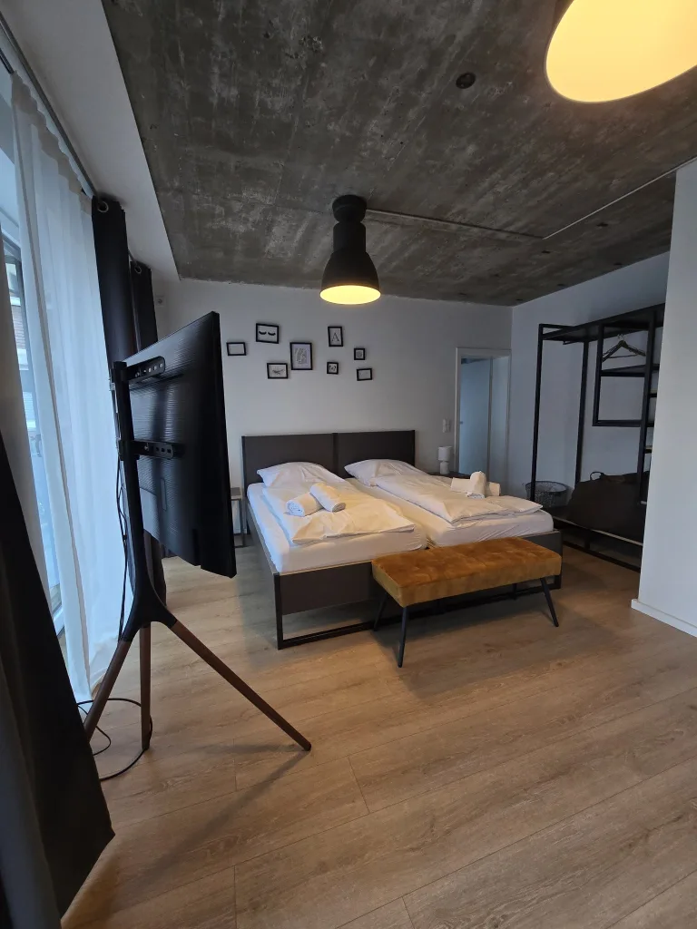 Doppelbett des Viertelnests mit Pendelleuchte und Spiegel